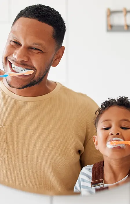 Happy Mixed Race Father And Son Brushing Their Teeth Together In A Bathroom At Home. Single African American Parent Teaching His Son To Protect His Teeth 1403045742 4936x3293
