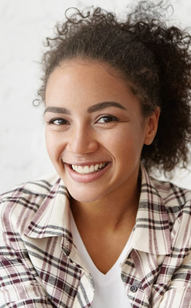 Smiling Young Woman At A Cafe With Dental Veneers