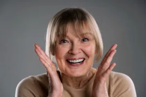 Older Lady With Denture Smiling 300x200