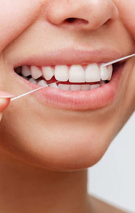 Close Up Of A Young Woman Flossing Her Teeth After Meal On White Background. Dental Health Care 1441471859 3646x2430