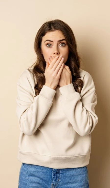 Woman Scared Covering Mouth Is Anxious At The Dentist